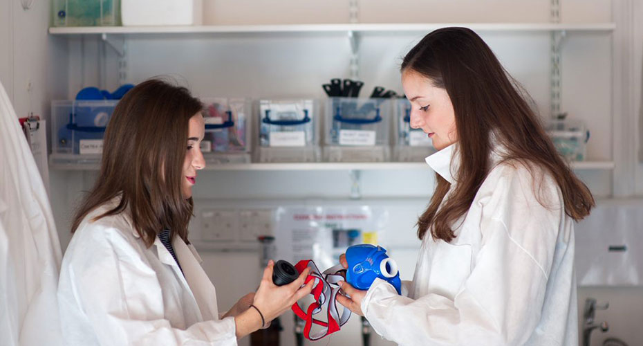 Students in lab coats and masks